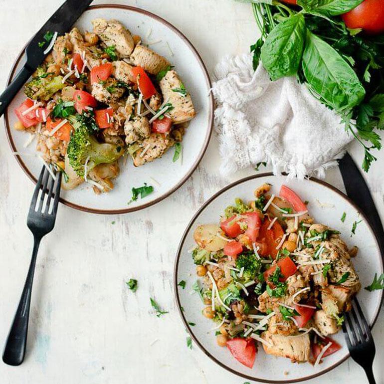 Recipe image of two plates of Italian chicken and farro with cutlery